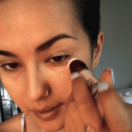 Mytour editor applying the concealer under their eyes.