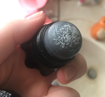 The cap is removed to reveal the salt on top of the remover.
