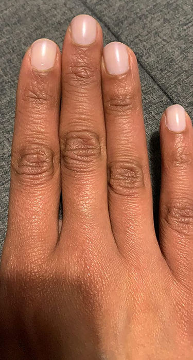 A reviewer wearing the soft pink version
