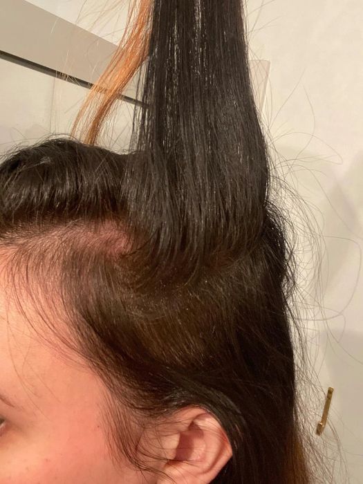 Reviewer showcasing their hair after applying the root cover-up spray, with a uniform color throughout