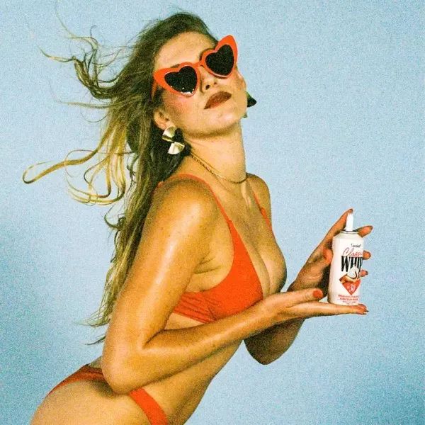 A model holding the sunscreen