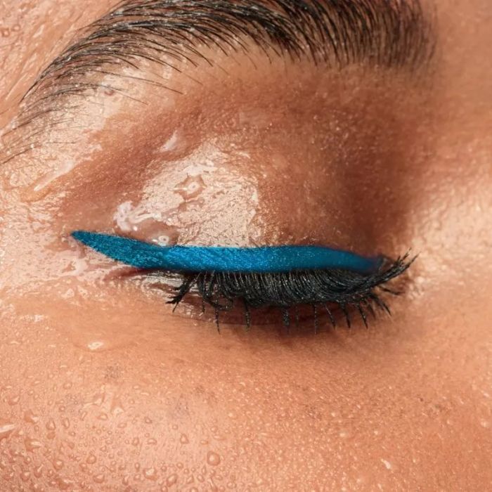 A model wearing turquoise eyeliner