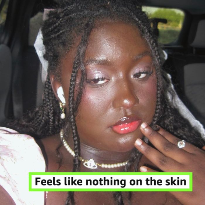 A person with braided hair wears earphones, lipstick, and pearl jewelry, striking a pose with their hand near their face. Text reads: 