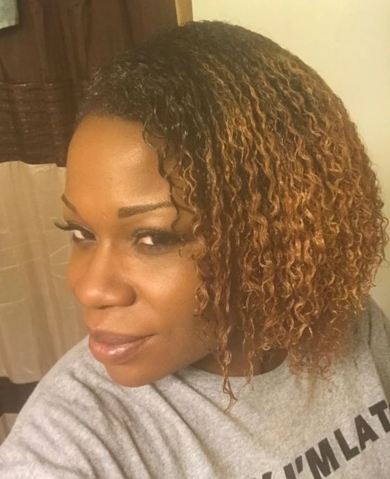a reviewer showing their defined curls after using the brush