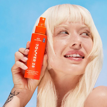 Model holding the Tower 28 spray