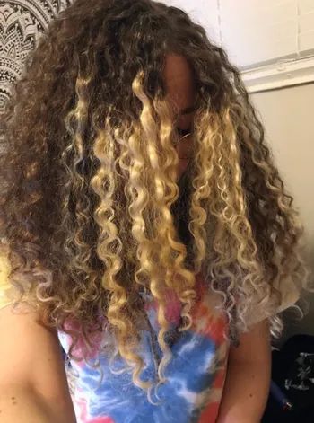 A person with long curly hair.