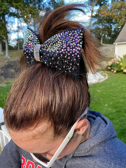 A reviewer sporting a sleek, slicked-back ponytail.