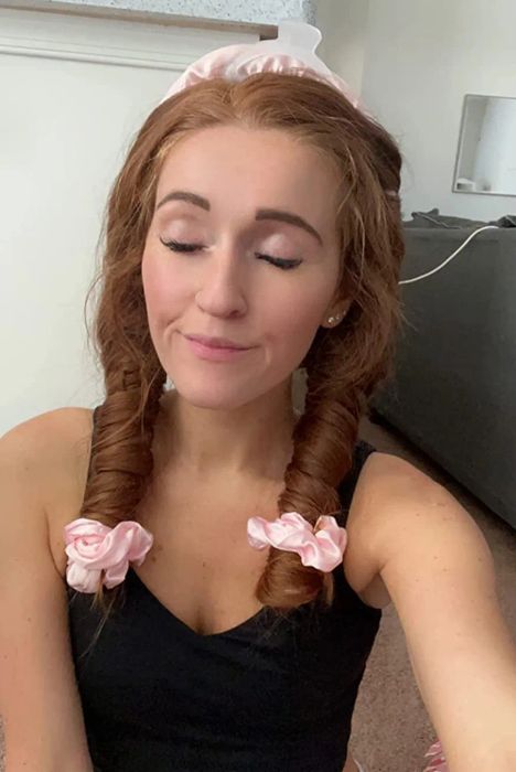 A reviewer with their hair wrapped in the heatless curler before going to bed
