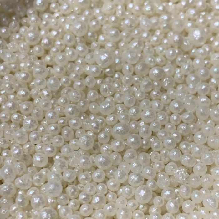 A close-up view of delicate pearls, perfect for jewelry crafting or other creative projects.
