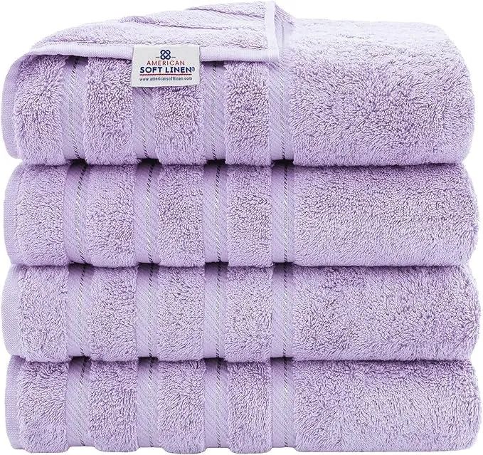 A stack of four plush bath towels, each clearly labeled for easy identification.