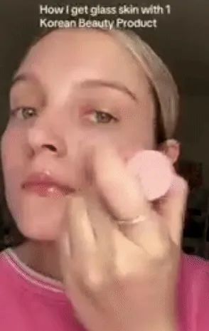 A model applies a multibalm to their face