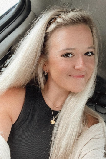 A reviewer with long blonde hair wearing a stylish headband