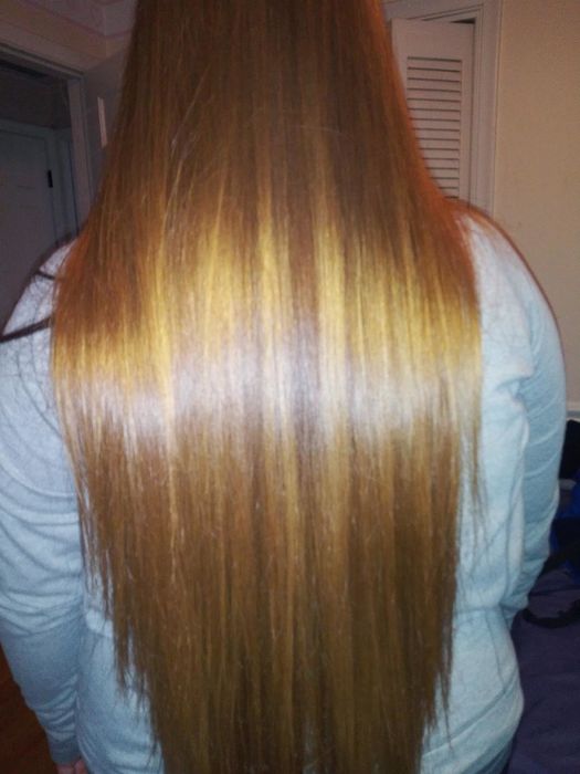 A reviewer with shiny, long, straight hair
