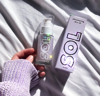 A bottle of Sol Body shimmering dry oil
