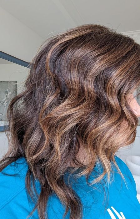 The same customer with smoother, healthier highlighted brown hair after using the K18 mask