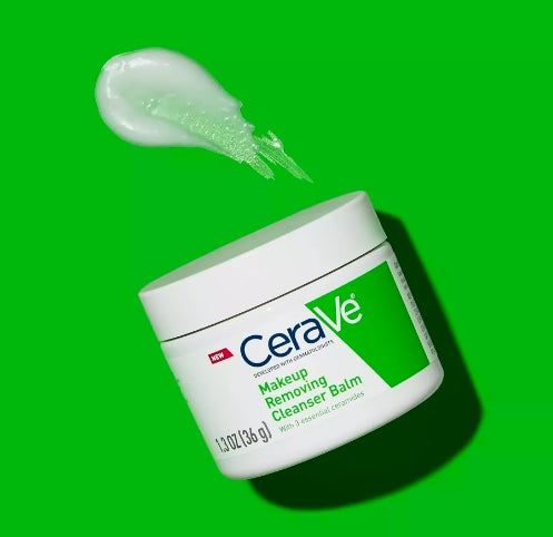 CeraVe Makeup Removing Cleanser Balm shown against a green background, with a smear of the balm above the container.