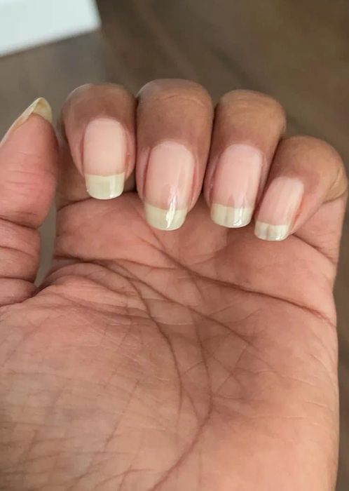 Close-up shot of a hand displaying naturally well-maintained fingernails.