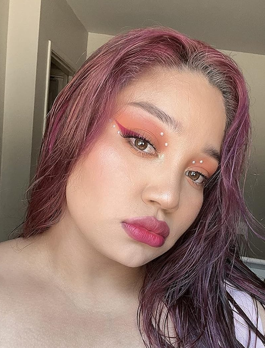 The reviewer with a full face of makeup before using the cleansing balm.