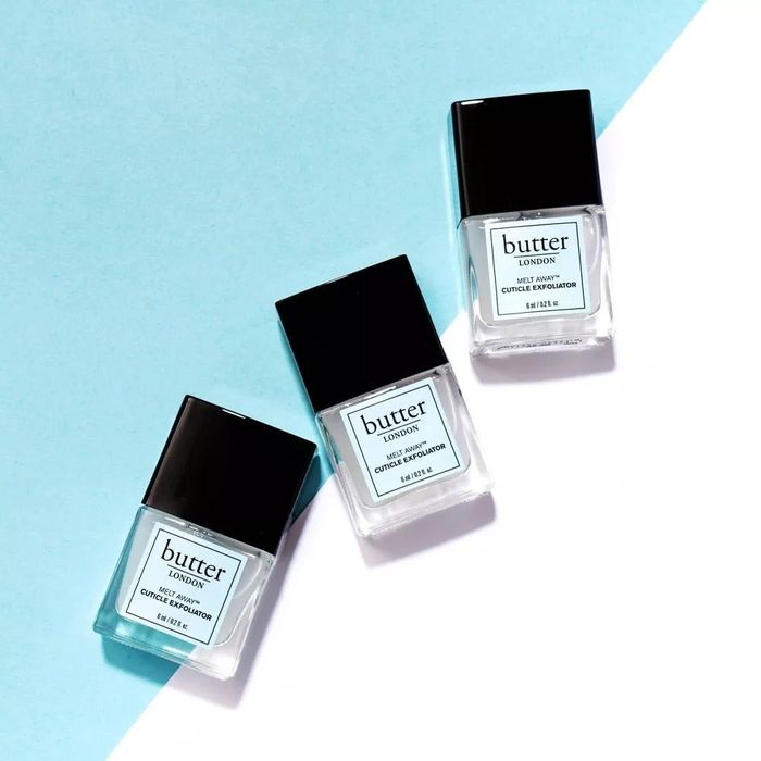 Three bottles of Butter London Melt Away Cuticle Exfoliator arranged diagonally against a light background