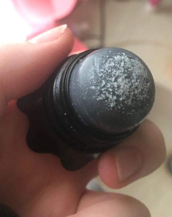 The cap is removed to reveal the salt on top of the remover