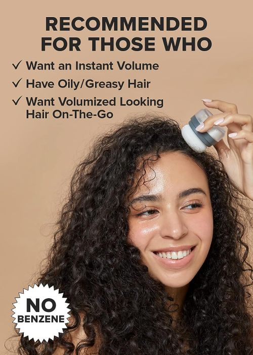 A model applying the dry shampoo powder with a puff applicator to their curly hair for a quick refresh