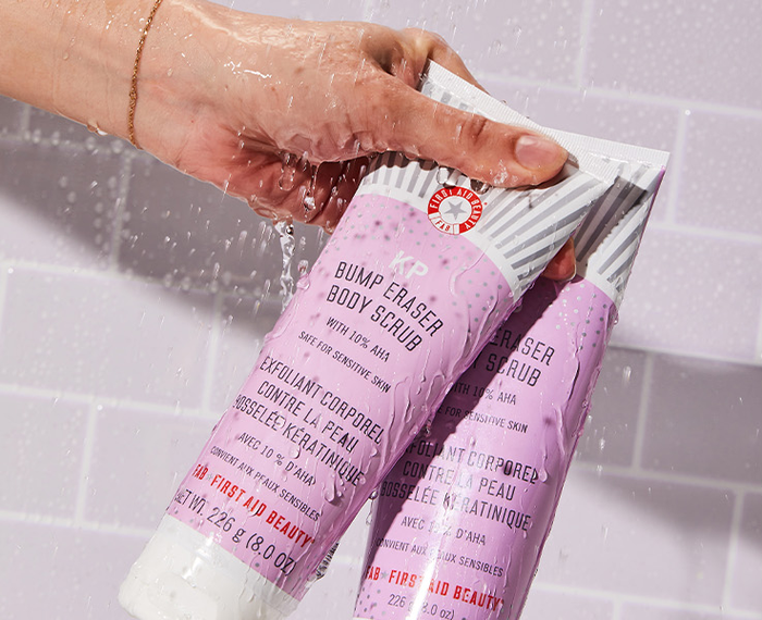 A hand holding the scrub exfoliant