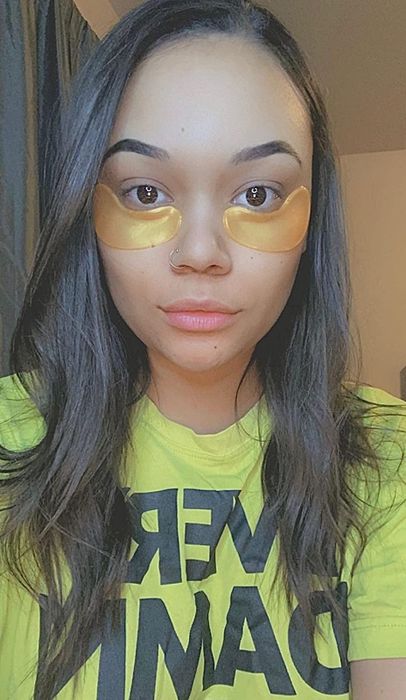 A reviewer wearing under-eye masks for a refreshing, rejuvenating effect