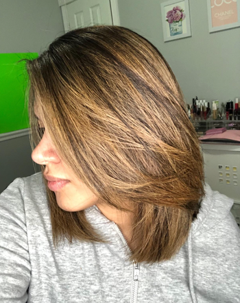A reviewer with sleek, straightened blow-dried hair