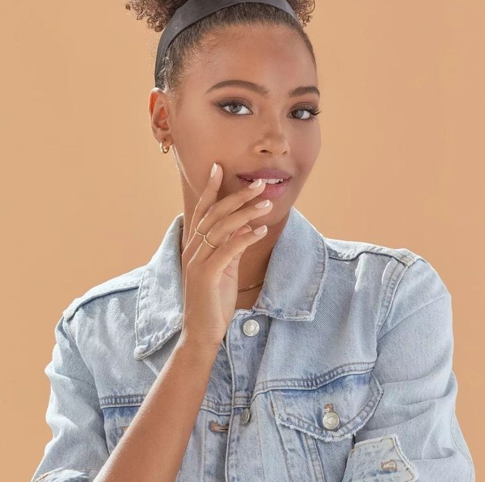 A model showcasing the imPRESS press-on nails, perfectly applied for a chic look