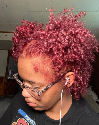 Reviewer’s hair transformed into a vibrant red after applying the dye.