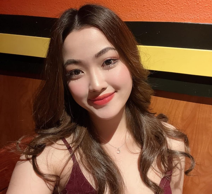A reviewer wearing a warm orange-brown lip shade.