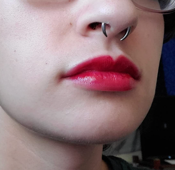 Reviewer rocking a bold red lip stain