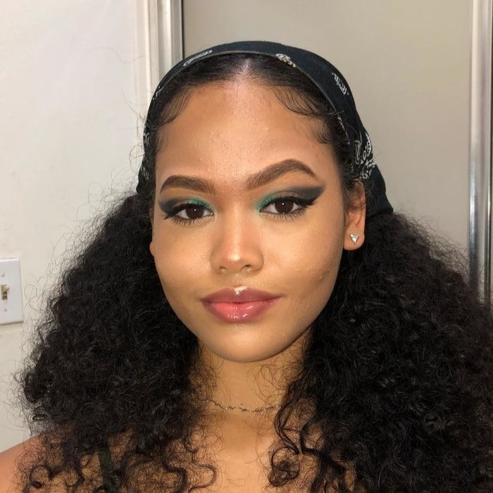 A reviewer wearing the eyeliner paired with striking blue eyeshadow