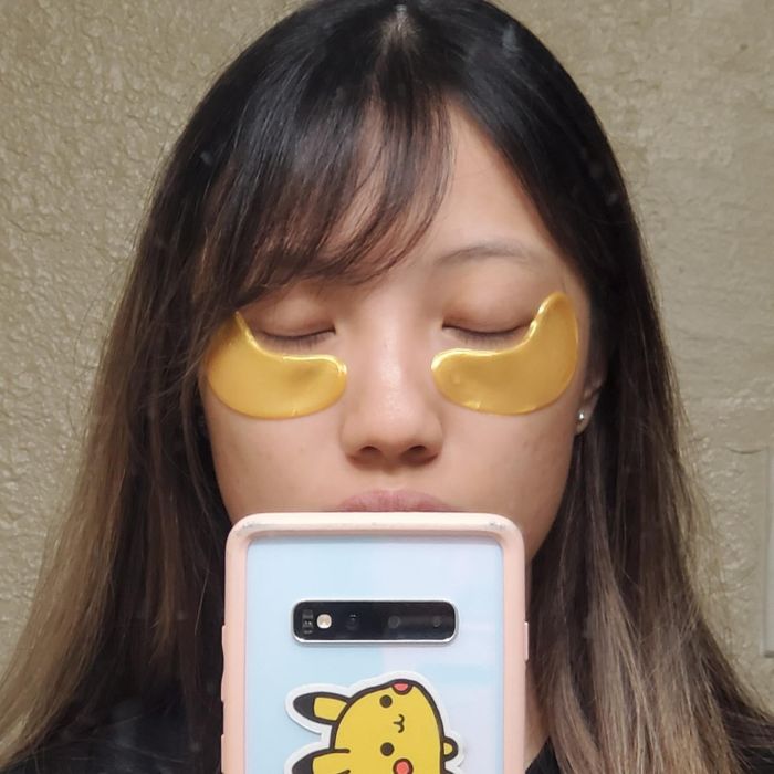 A reviewer wearing the golden eye patches.