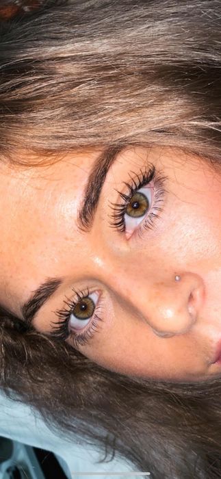 A reviewer with super long lashes, wearing Essence mascara