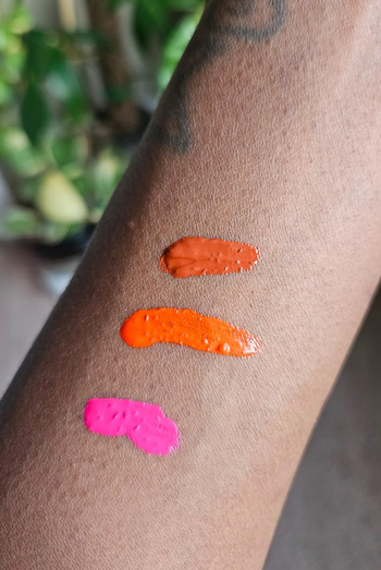 Three different blush shades swatched on the reviewer's arm