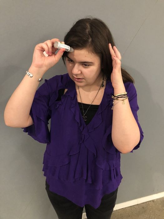Mytour editor applying the stick to her forehead