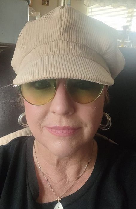 An older reviewer with plump, moisturized-looking skin.