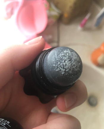 A reviewer's image showing the scrub stick with extractions from their skin