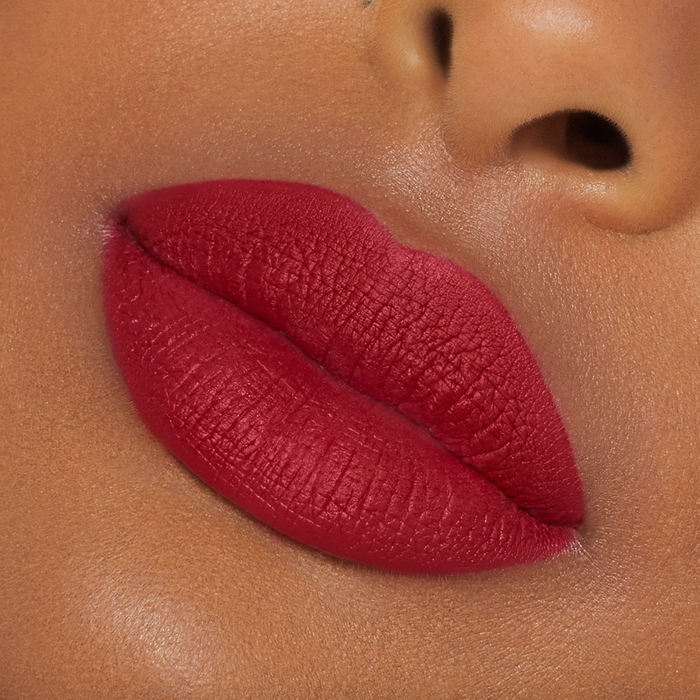 A model wearing a bold red lip