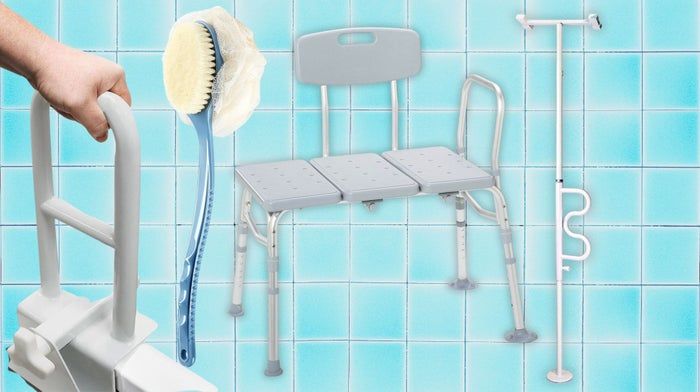 A shower transfer bench, grab bars, a long-handled body brush, and a tension-mounted grab pole.