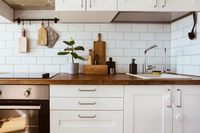 A white kitchen paired with a wooden countertop