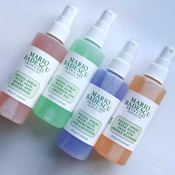 Four bottles of Mario Badescu facial sprays, each with a different label: rosewater, cucumber and green tea, chamomile and lavender, orange blossom