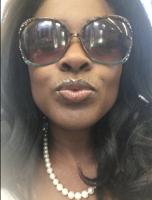 A reviewer wearing the lip liner beneath a layer of lip gloss.