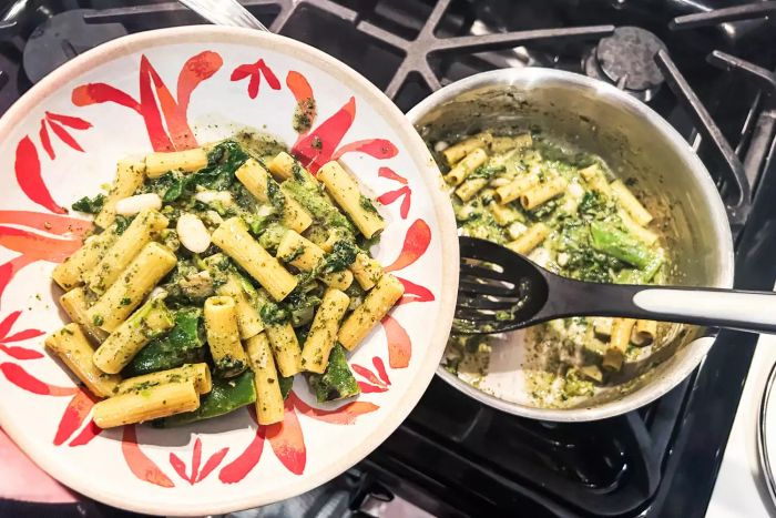 A person serves a cooked Daily Harvest Meal Kit pasta bowl