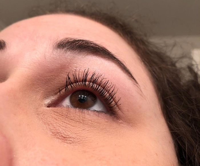 A person flaunting beautifully feathered lashes thanks to this comb