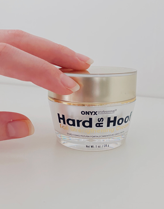 Reviewer’s hand holding a jar of Onyx Professional Hard as Hoof nail strengthening cream