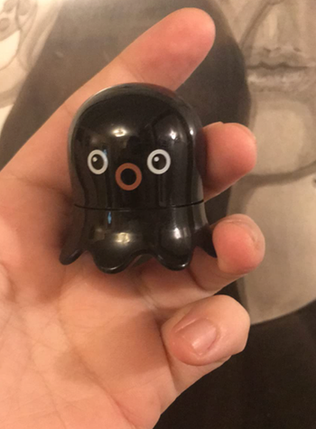 A reviewer holding a facial blackhead remover stick, ready for use