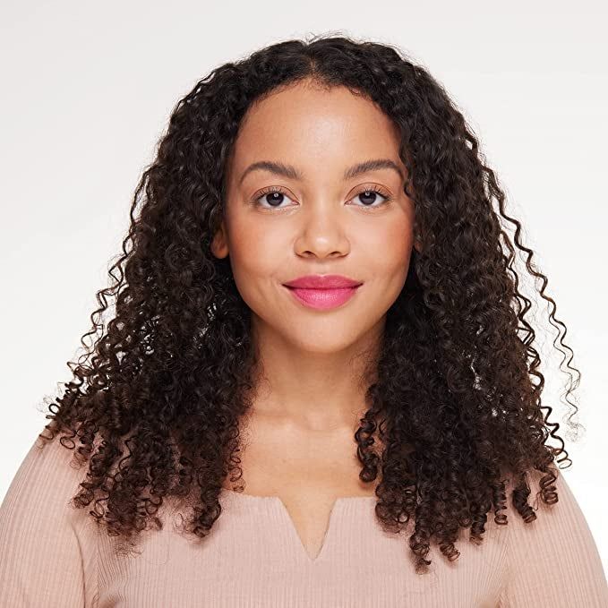 A model showcasing a soft pink lip stain.