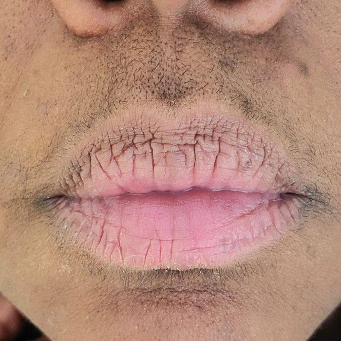Reviewer's face before using the shaver